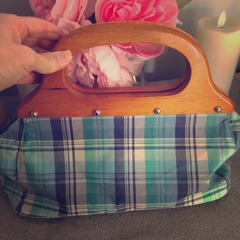 Plaid purse with wooden handles.